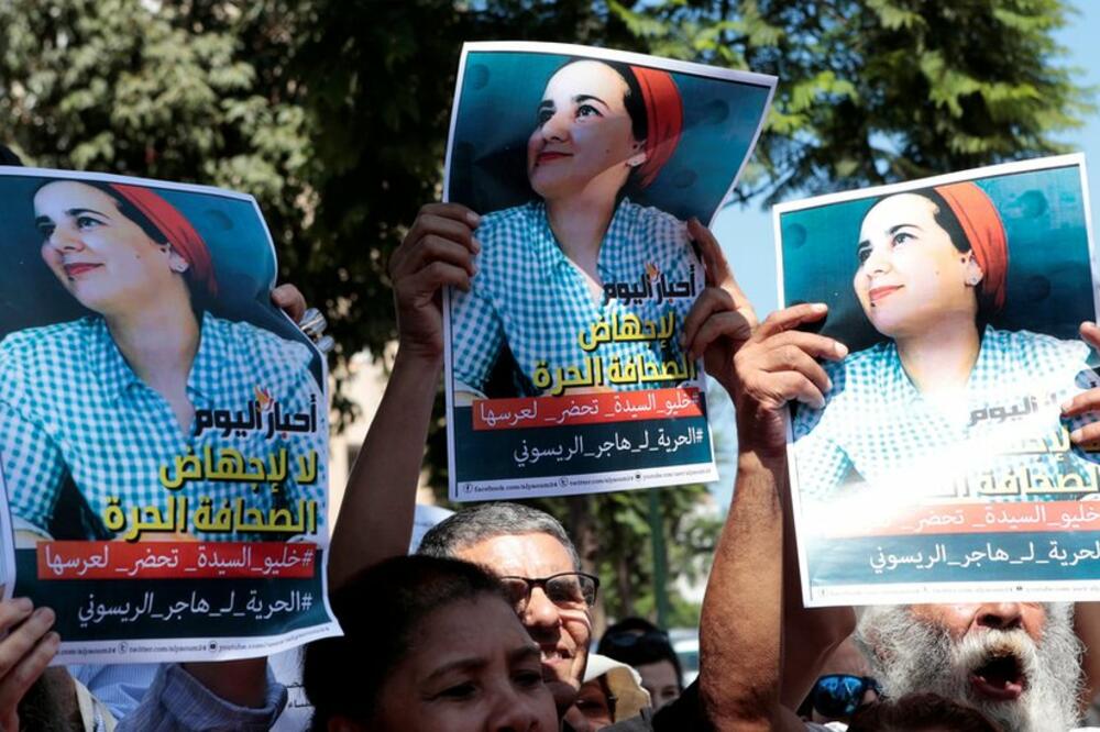 Aktivisti sa posterima uhapšene novinarke ispred suda, Foto: Reuters