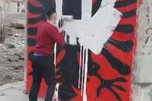 Young men crossed over the graffiti with the Albanian flag in Tuzi