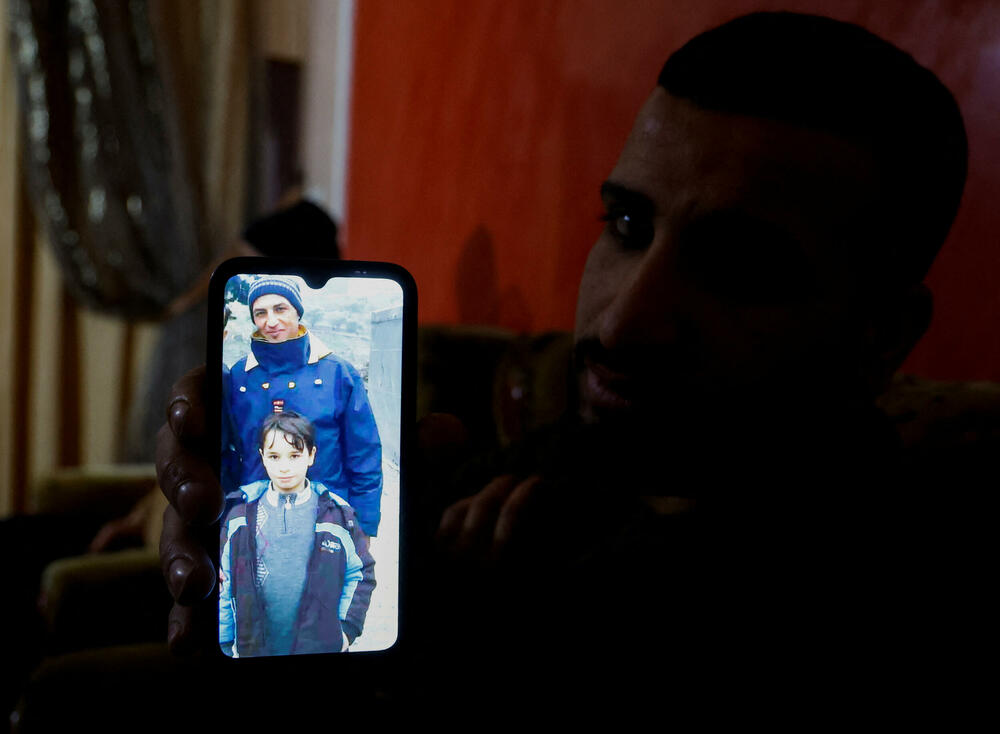 Rođak stradalog Palestinca pokazuje njegovu fotografiju