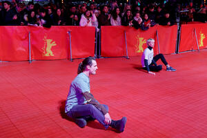 Two activists stuck to the red carpet during the opening...