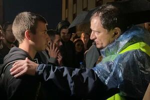 A small political debate in the rain of the "Serbia against violence" protest:...