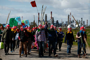 Environmental activists disguised as clowns stormed an oil refinery in...
