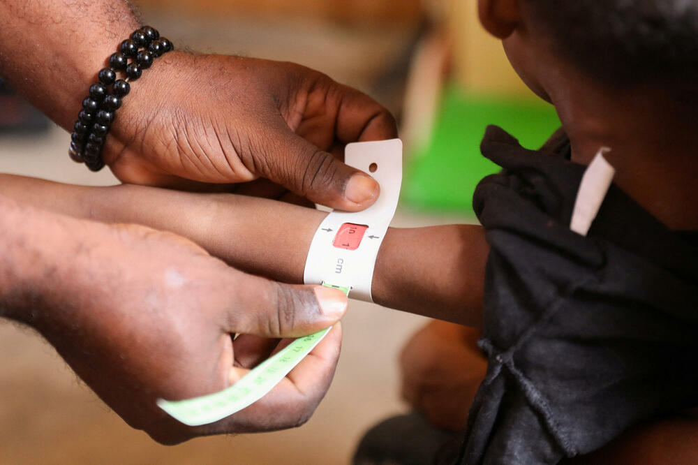 A health worker checks a child for malnutrition at a mobile health clinic for people displaced by gang violence, Haiti, Photo: reuters