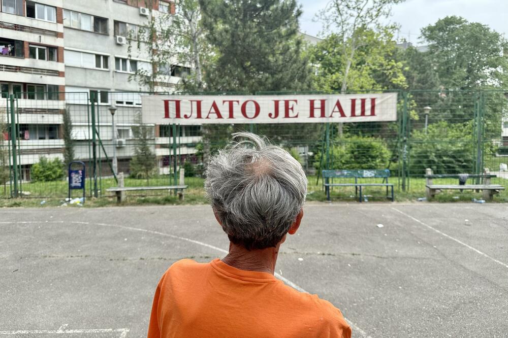 A member of the civic initiative in front of the "Plato is ours" banner, Photo: D. Dedović