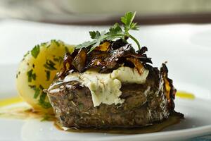 Steak with flavored butter and caramelized red onion
