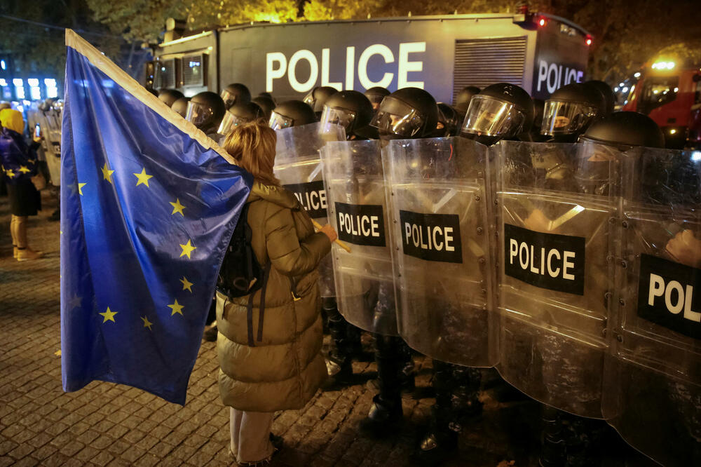 Pristalica gruzijske opozicije ispred kordona policije tokom protesta u četvrtak, Foto: Rojters
