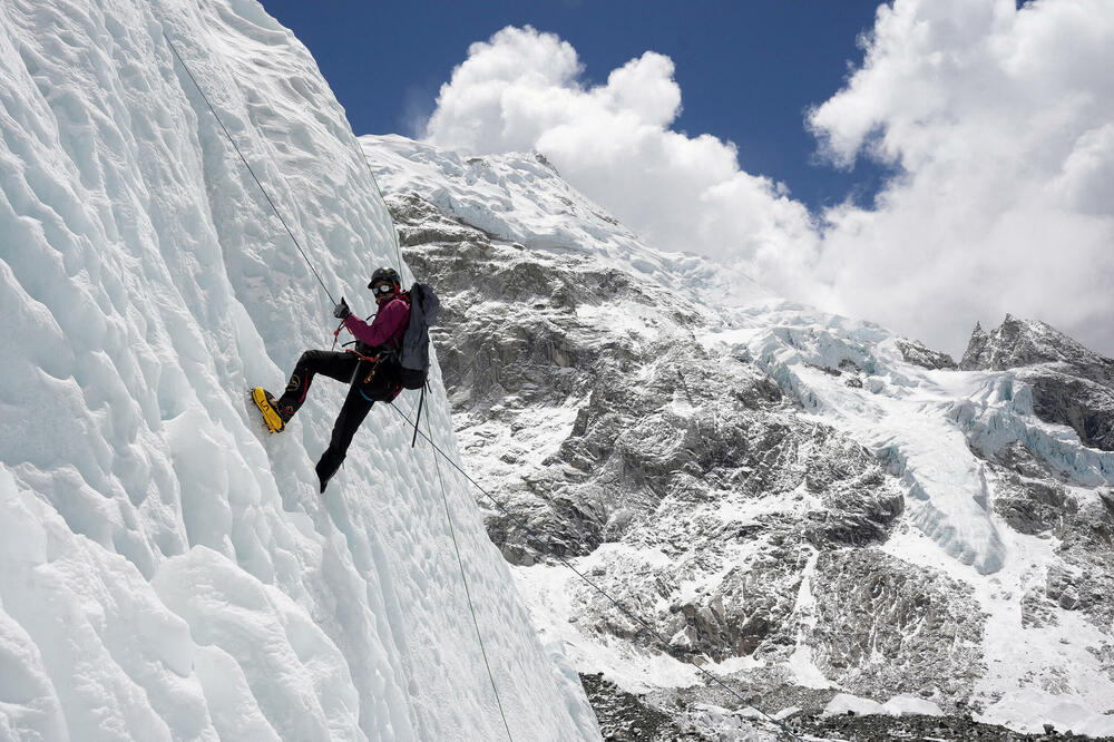 Planinar se drži za uže tokom penjanja po ledu u baznom kampu Everesta, Foto: REUTERS