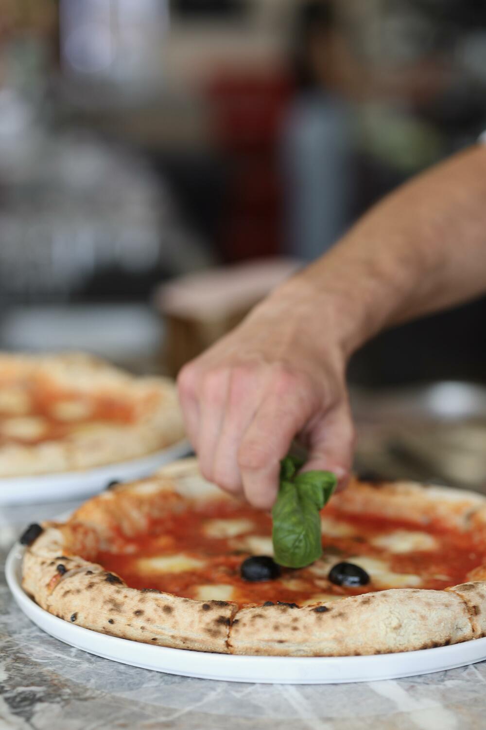 Pizza master in action at Piazza Restaurant