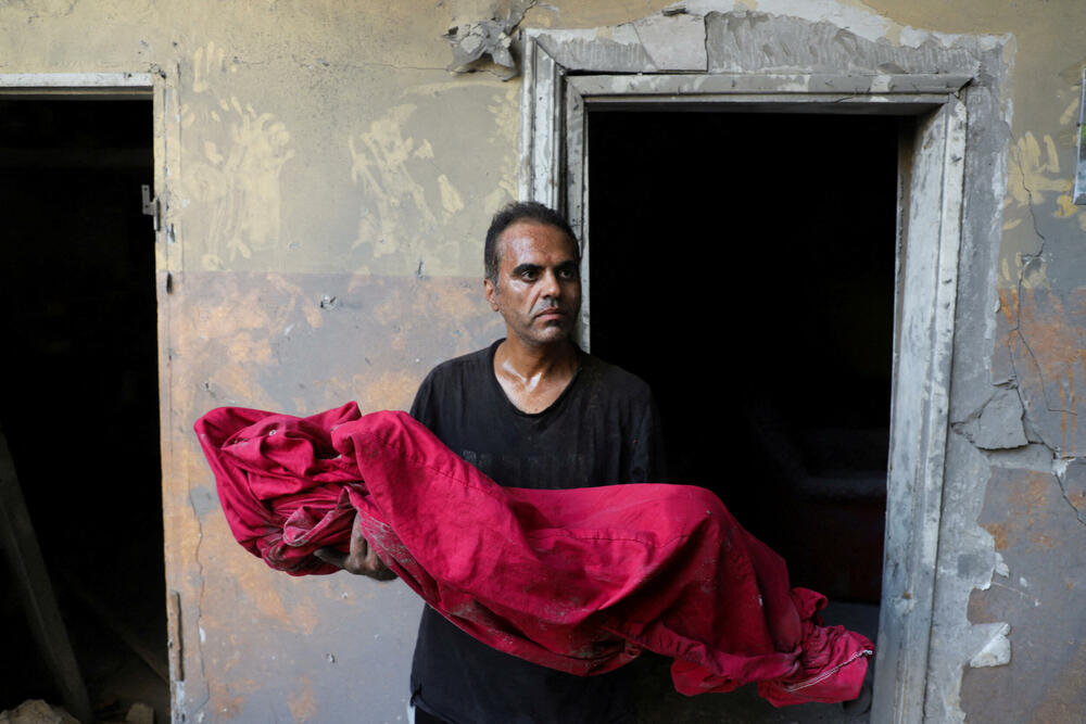 Palestinac Šadi Mansur nosi tijelo svog sina Amira koji je stradao u izraelskom napadu