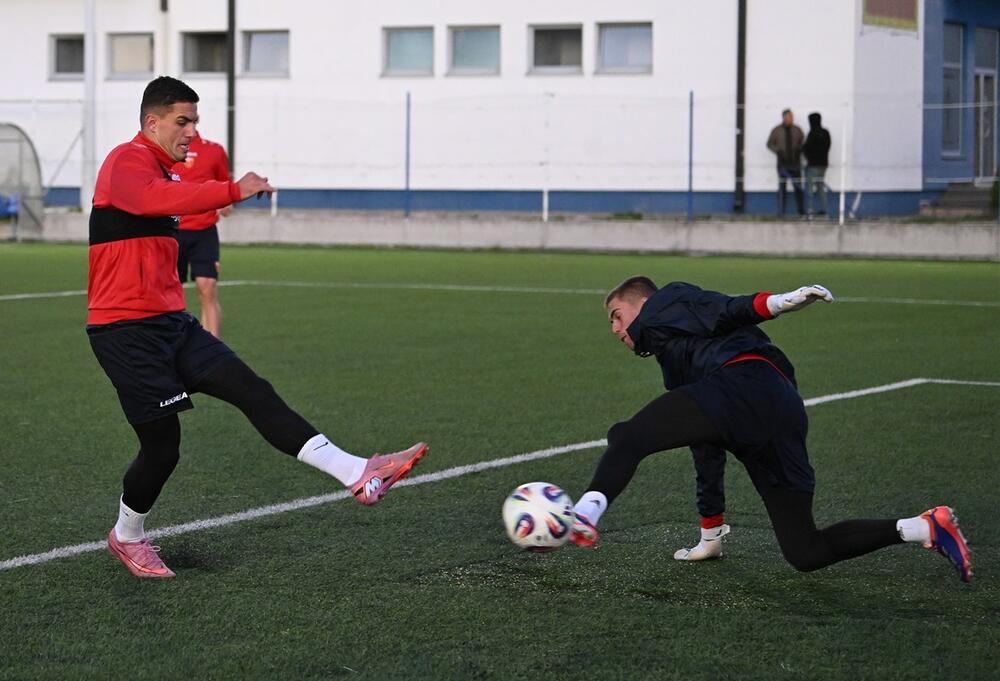 Krstović and goalkeeper Popović at a training session our team conducted on an artificial surface