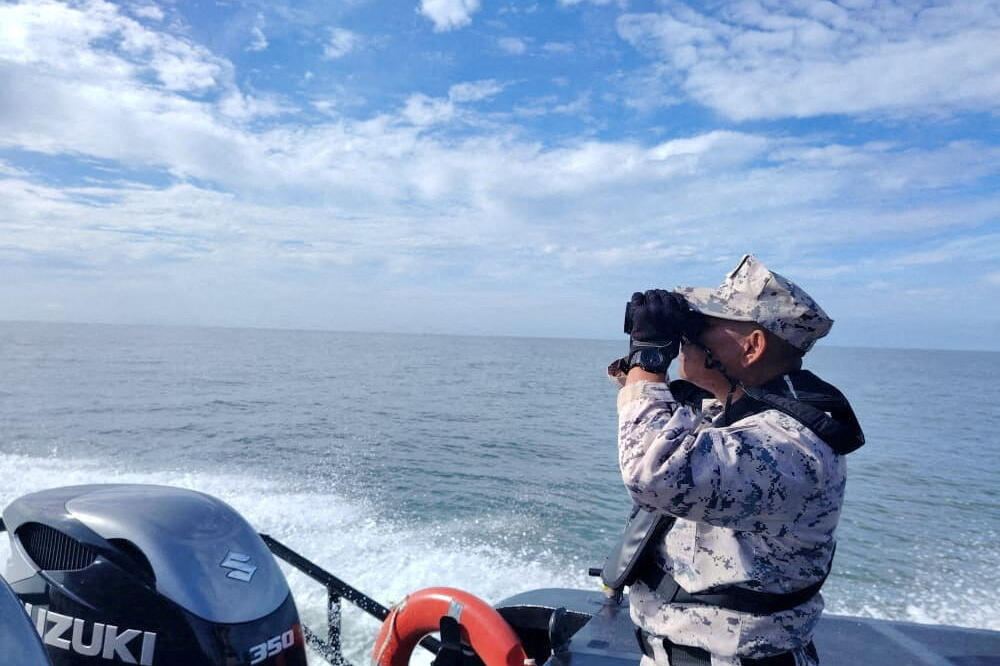 Službenik malezijske obalske straže, Foto: Reuters