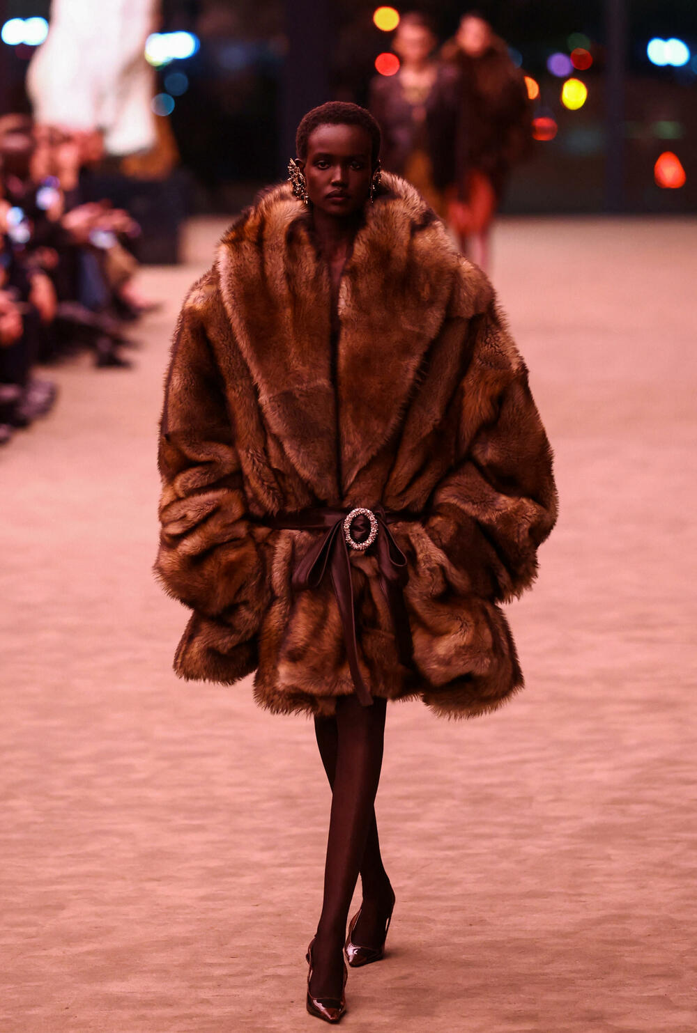 <p>Revija je otvorena nizom moćnih crnih odijela sa velikim reverima i naglašenim ramenima - što priziva ženski smoking koji je francuski dizajner Ivo Sen Loran kreirao 1966. godine, kršeći tadašnju tradiciju</p>