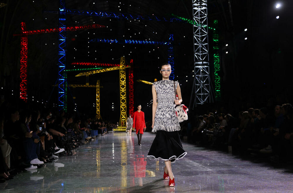 <p>Kostimi su bili kombinovani sa neuvučenim košuljama u kontrastnim dezenima i bojama, te upareni sa klasičnim Šanelovim dvobojnim salonkama u upadljivim kontrastima poput crvene i prelivajuće lila nijanse</p>